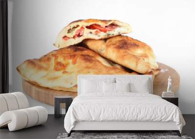 Pizza calzones on wooden board isolated on white Wall mural