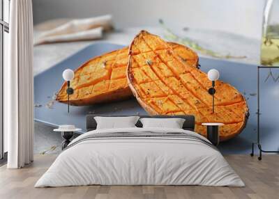 Plate with baked sweet potato on table Wall mural