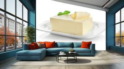 Plate with piece of butter on white background Wall mural