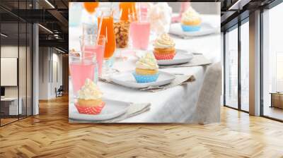 Plates with tasty cupcakes on table Wall mural