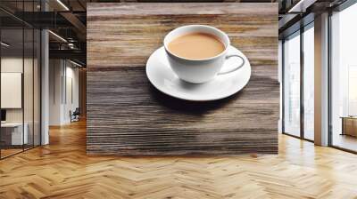 Porcelain cup of tea with milk on wooden background Wall mural