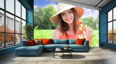 Portrait of beautiful young woman with poppies in the field Wall mural