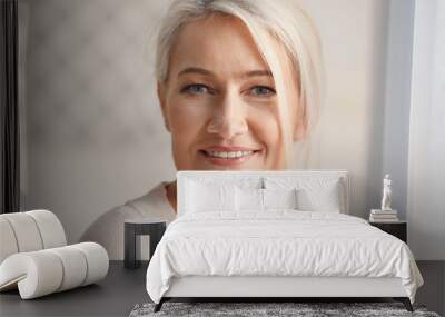 Portrait of smiling mature woman at home Wall mural