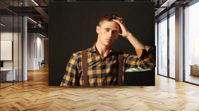 Portrait of stylish man on dark background Wall mural