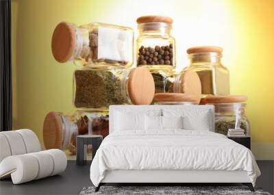 powder spices in glass jars on yellow background Wall mural