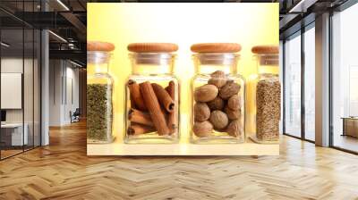 powder spices in glass jars on yellow background Wall mural