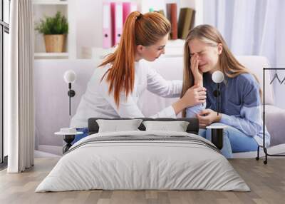 Professional psychotherapist talking with young girl indoors Wall mural