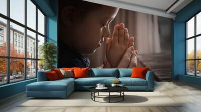 Religious Christian girl praying with her mother indoors Wall mural