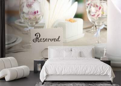 reserved sign on restaurant table with empty dishes and glasses Wall mural