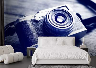 retro camera on wooden table in shades of grey, closeup Wall mural