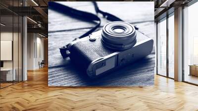 retro camera on wooden table in shades of grey, closeup Wall mural