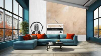 Retro radio, headphones and microphone on table against light wall Wall mural