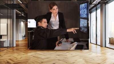 Security guards working in surveillance room Wall mural