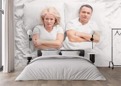 Senior couple with problem in relationship on bed Wall mural