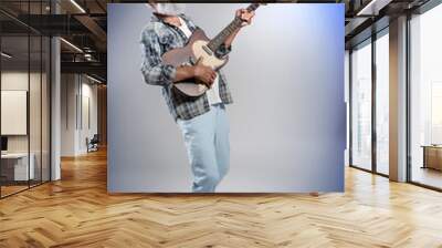 Senior man with guitar on grey wall background Wall mural