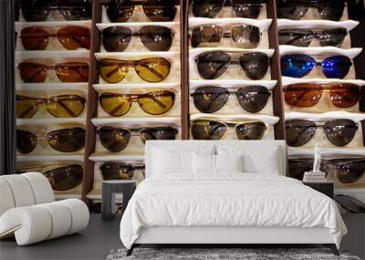 Showcase with different sunglasses in shop Wall mural