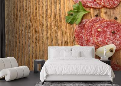 Slices of salami with cloves of garlic and spices Wall mural