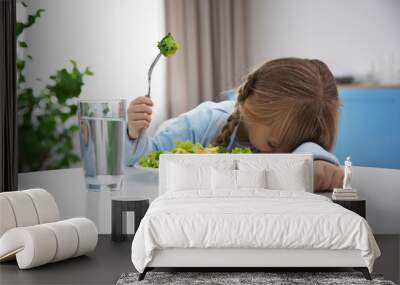 small girl refusing to eat vegetable salad Wall mural