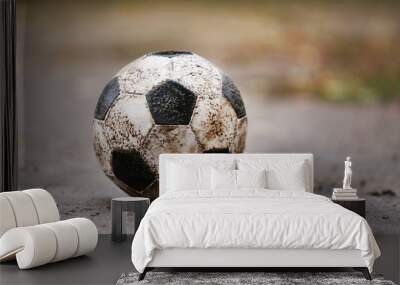 Soccer ball on ground in rainy day, outdoors Wall mural