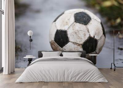 soccer ball on ground in rainy day, outdoors Wall mural