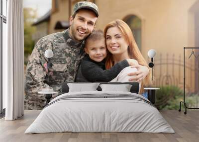 Soldier reunited with his family on a sunny day Wall mural