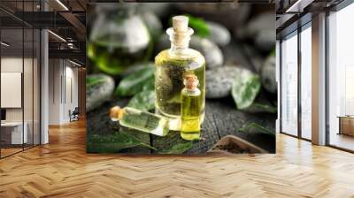 Spa composition with tea oil in glass bottles and fresh leaves Wall mural