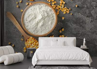 Spoon with kernels and corn starch in bowl on table Wall mural