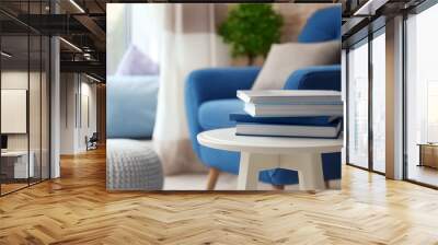 Stack of books on table and armchair in living room Wall mural