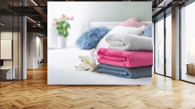 Stack of clean towels on bed Wall mural