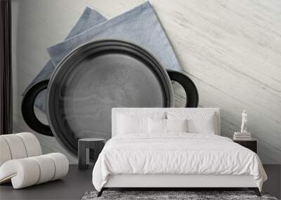 Stainless saucepan and napkin on white wooden table Wall mural