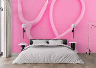 Stethoscope with pink ribbon on color background. Breast cancer concept Wall mural