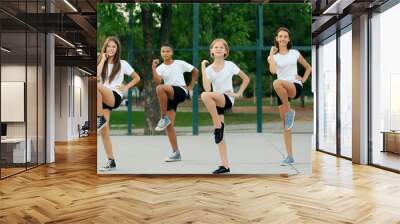 students doing physical exercises on school yard Wall mural