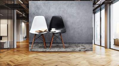 Stylish conception with white and black chairs on grey background Wall mural