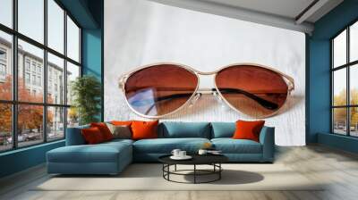 Stylish sunglasses on wooden background, closeup Wall mural