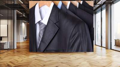 suits with shirts on hangers on wooden background Wall mural