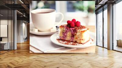 sweet cake with cup of tea on wooden table Wall mural