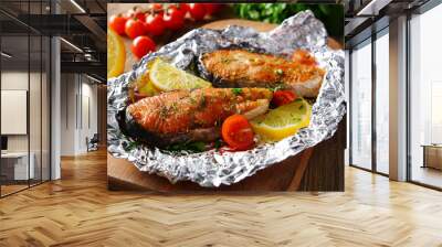 Tasty baked fish in foil on table close-up Wall mural