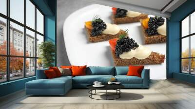 Tasty black caviar appetizer on plate Wall mural