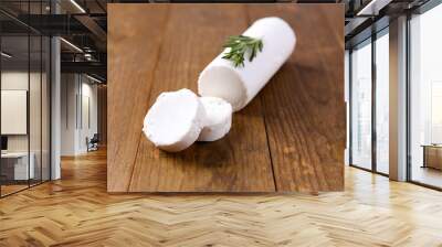 Tasty bushe cheese with rosemary, on wooden table Wall mural