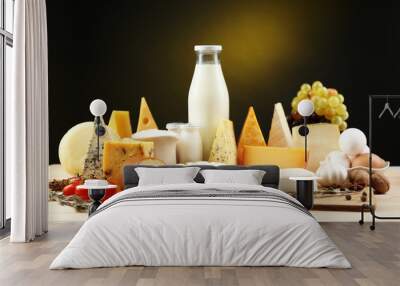 Tasty dairy products on wooden table, on dark background Wall mural