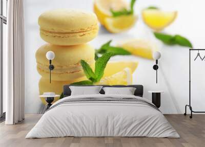 Tasty lemon macarons on white wooden table, closeup Wall mural