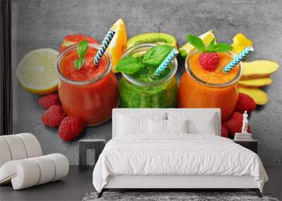 Tasty smoothie drinks with vegetables and fruits on table Wall mural