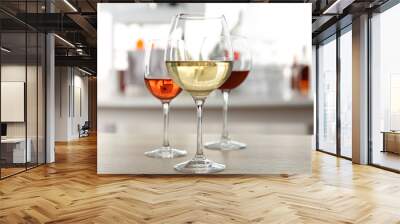 Three glasses with wine on kitchen table Wall mural