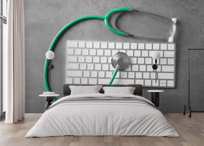 top view of green stethoscope and modern computer keyboard on light background Wall mural