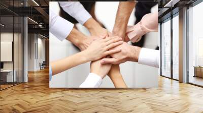 Top view of young people putting hands together Wall mural