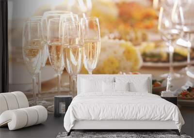 Tray with glasses of champagne on wooden table, close up view Wall mural