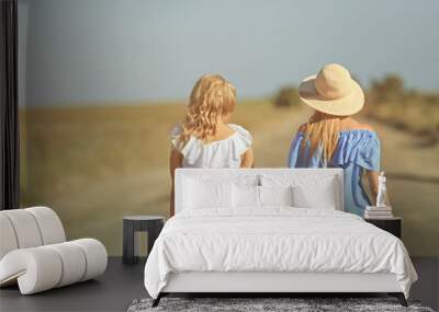 Two girls walking on road at countryside Wall mural