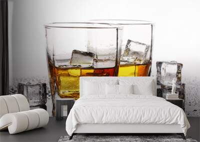 two glasses of scotch whiskey and ice on table isolated on white Wall mural