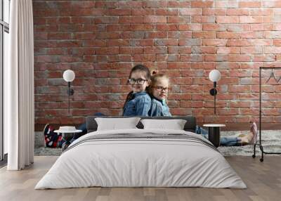 Two stylish little girls on wall background Wall mural