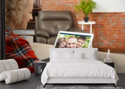 Video call and chat concept. Senior woman video conferencing on laptop Wall mural